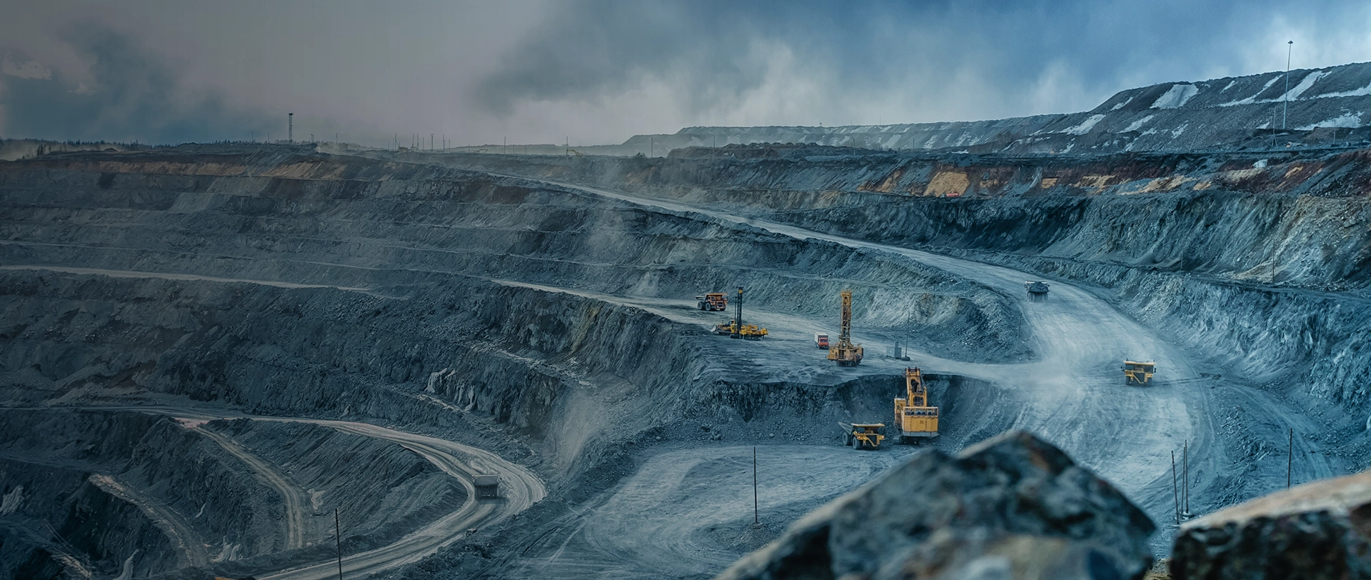 Open pit mine with heavy machinery, a key environment for our wear products.