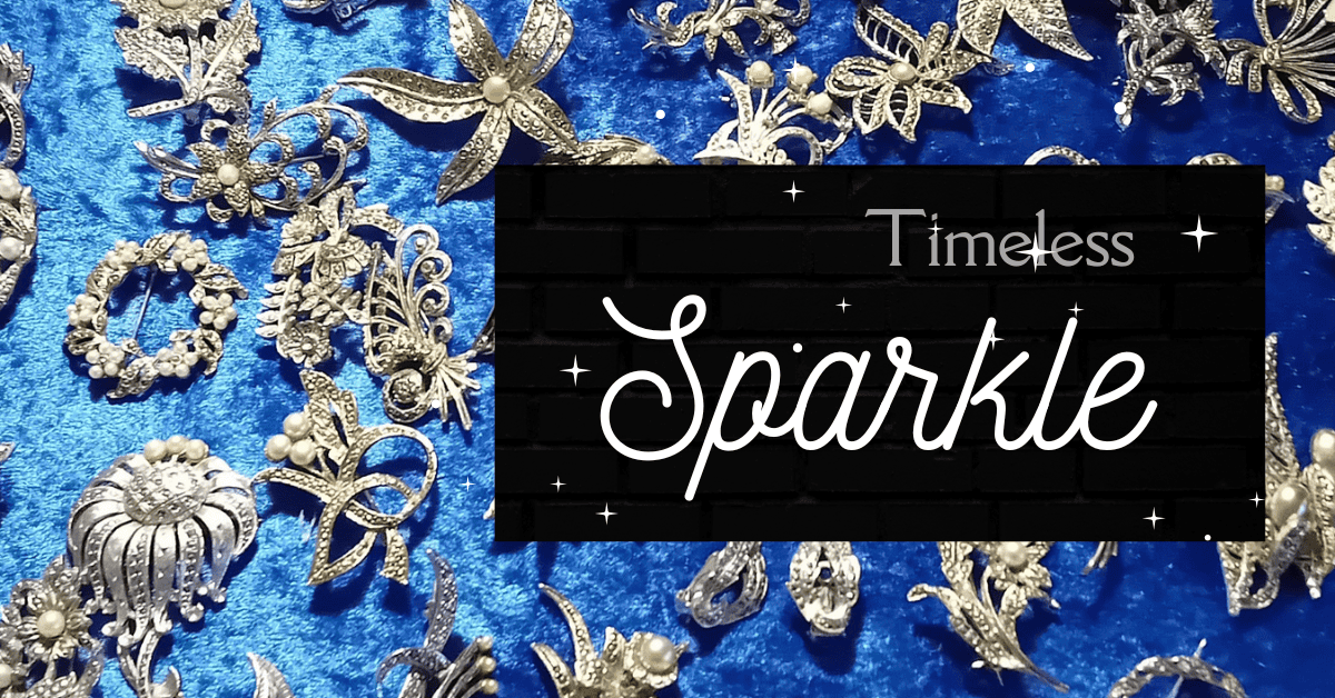 blue background with a variety of vintage marcasite brooches