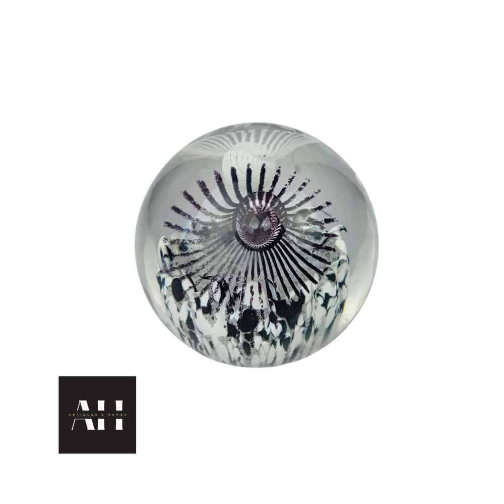 Caithness Luscious Lashes paperweight designed by Helen MacDonald in 2003, spherical glass with bold black and white lash motif, photographed for Antiques & Homes.