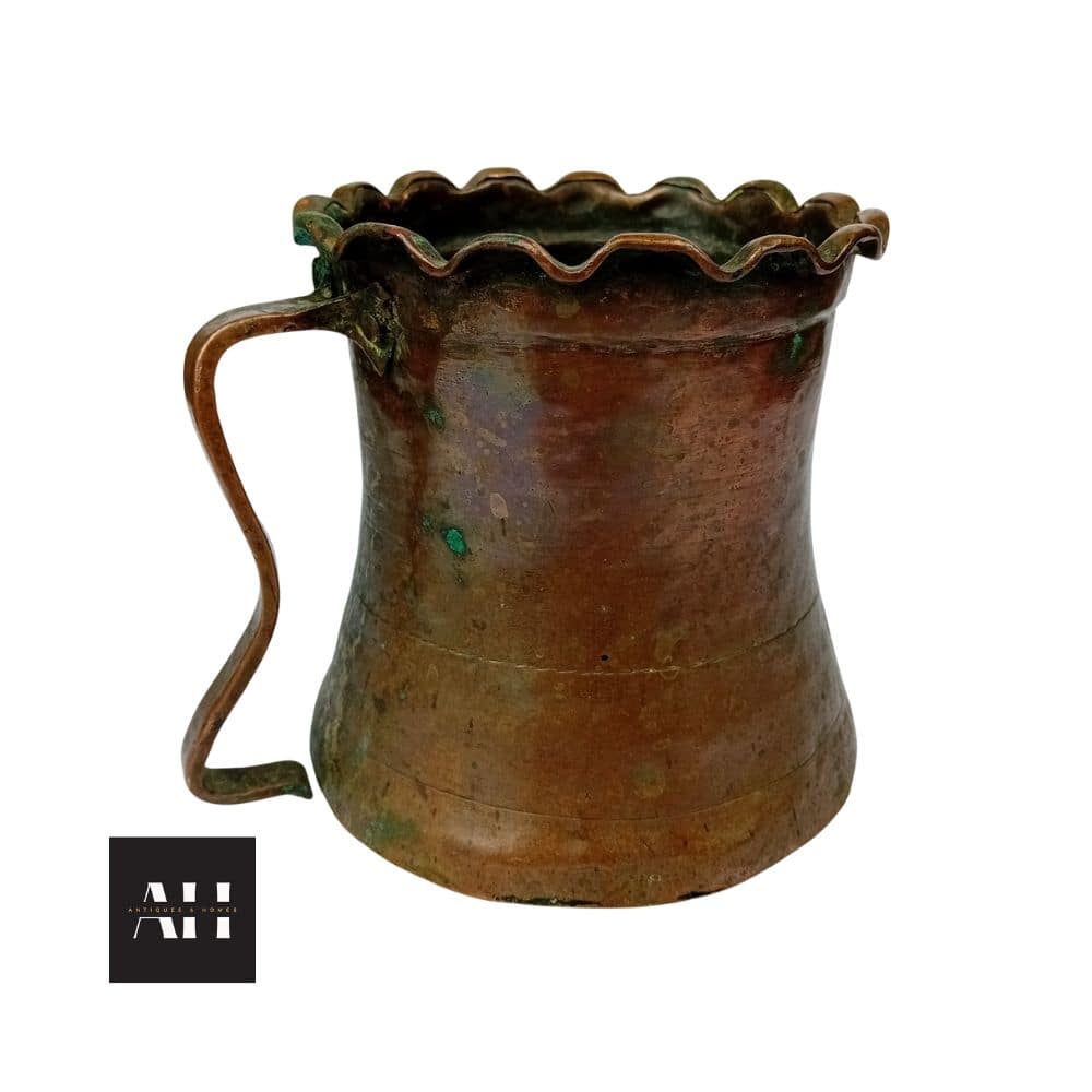 Side view of Antique Copper Tankard, 18th/19th century French copper measure with wavy rim, 13cm high, showing handle and patina.