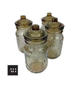 Image of four smoked glass vintage storage jars from Italy, 1970s, each with embossed fruit design and matching lids with plastic inserts.