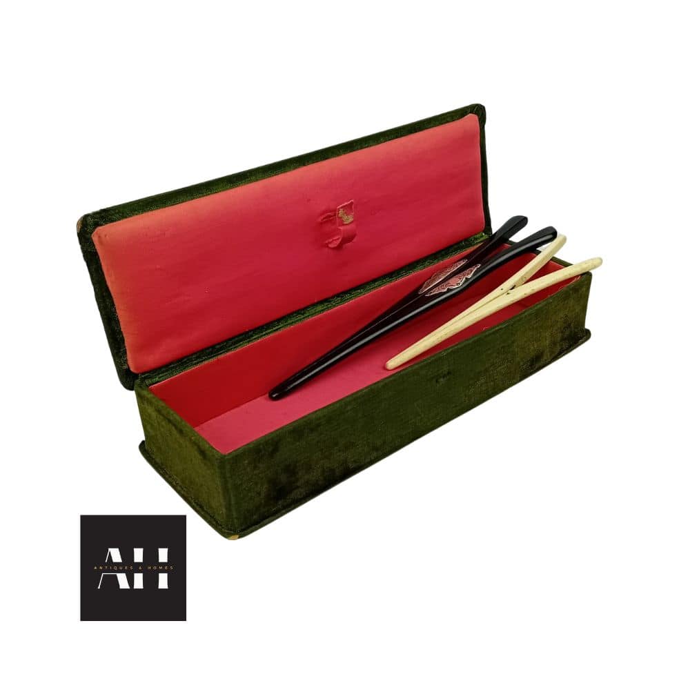 Pair of antique glove stretchers in original velvet box, including ebony with silver hinge and bone set, with decorative cartouche and patina.