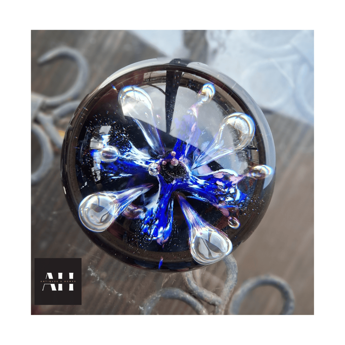 Side profile of a Caithness Moonflower Paperweight showing dome shape and studio glass clarity.