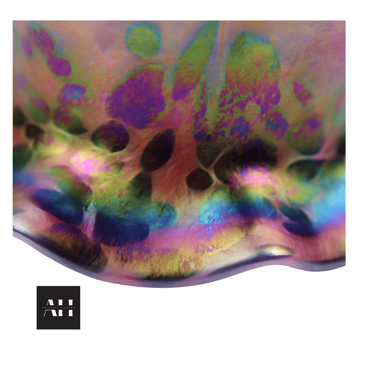 Base of Loetz style glass shade showing oil spot iridescence with rainbow colour shifts and frilled edge