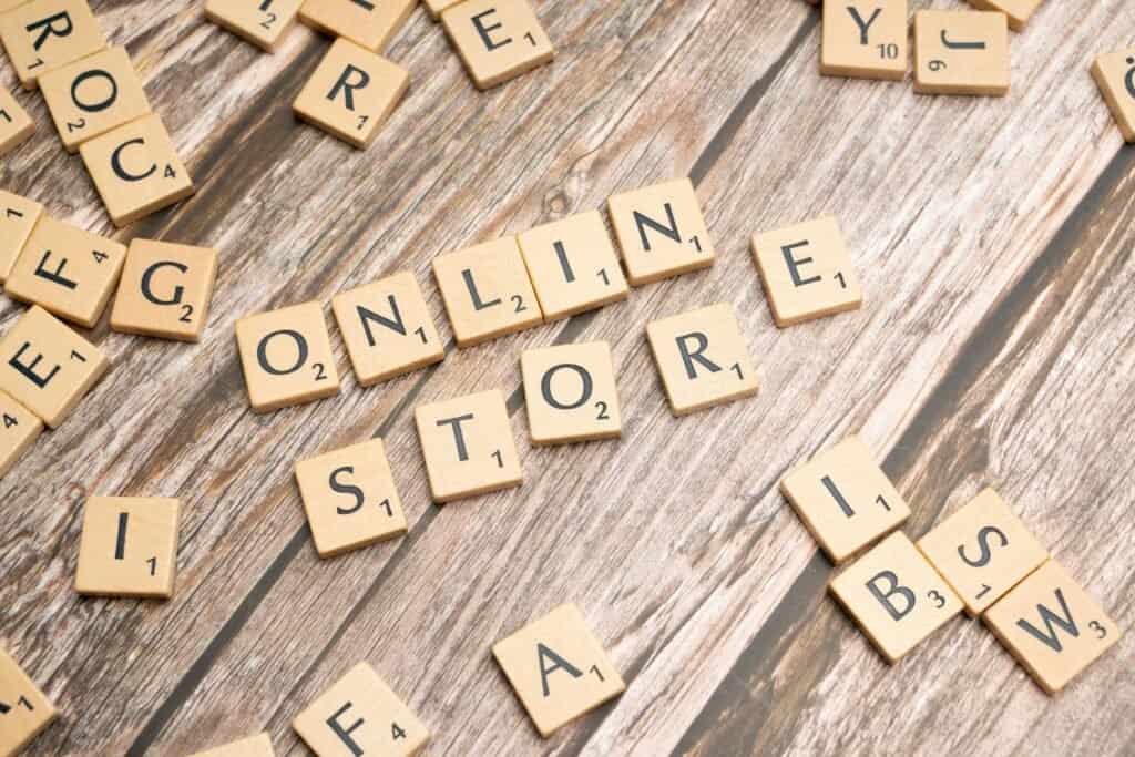Scrabble tiles spelling "Online Store" on a wooden surface. App marketplace concept.