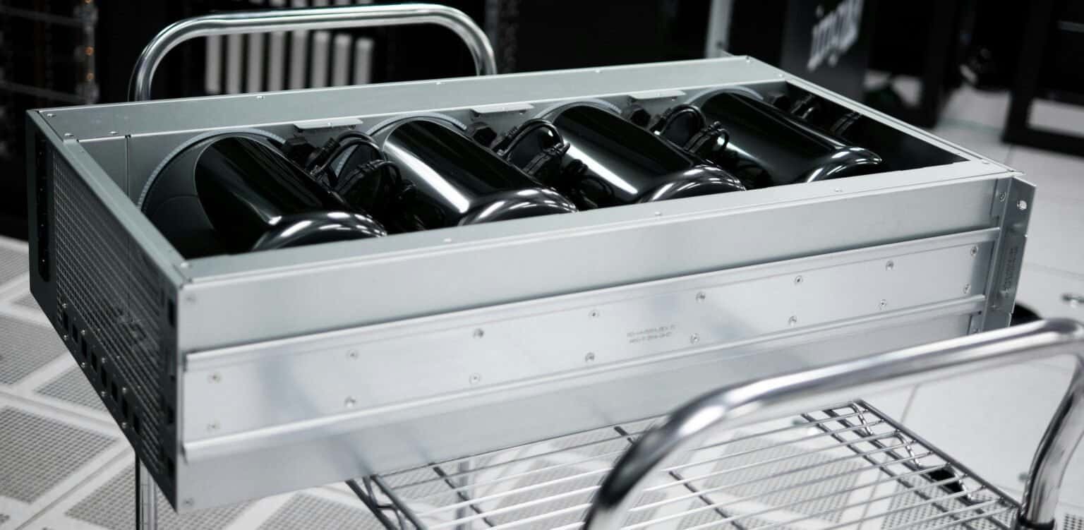 A rackmount server chassis with multiple black cylindrical components inside.