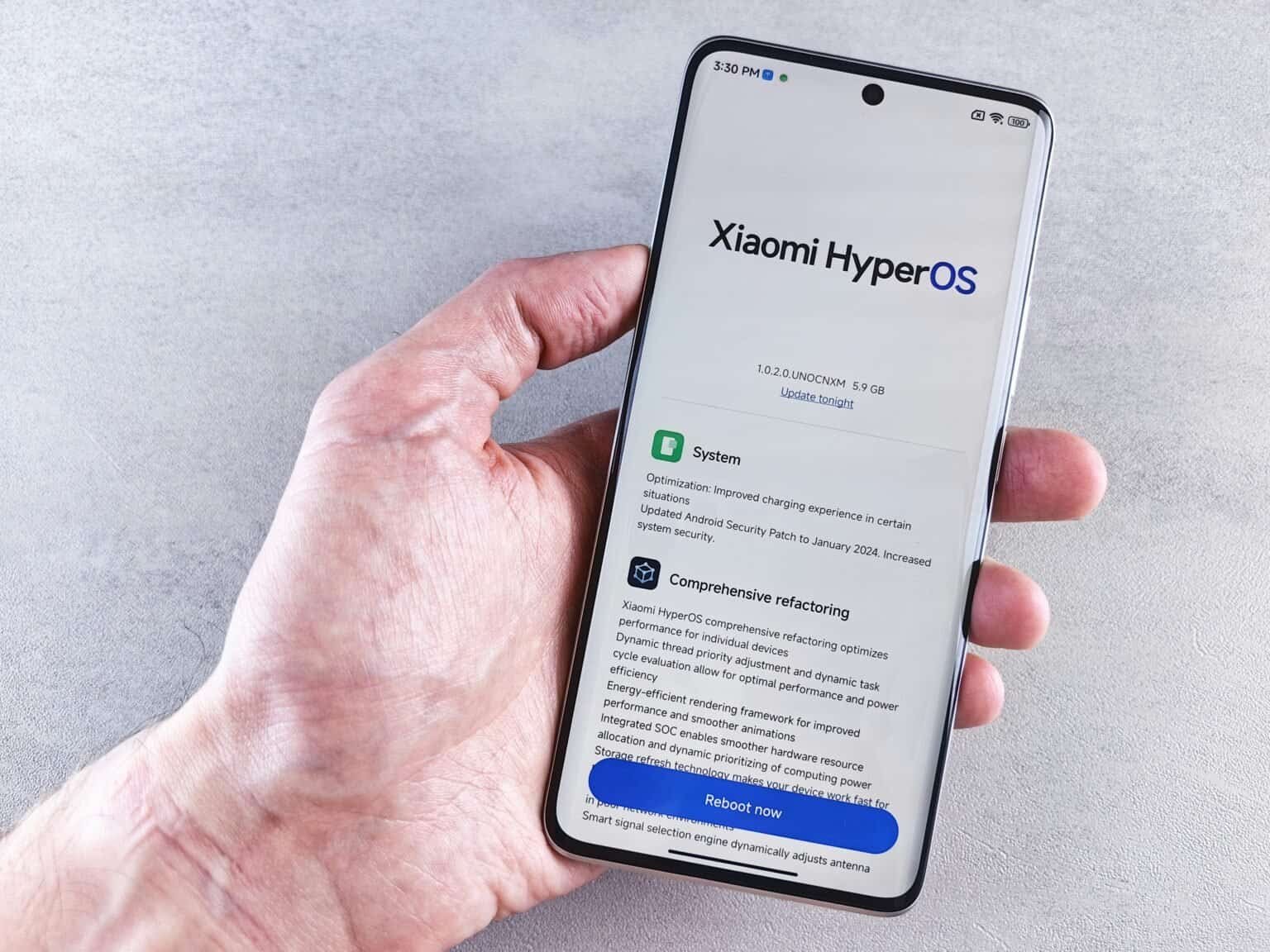 Xiaomi HyperOS update screen on a smartphone held in hand