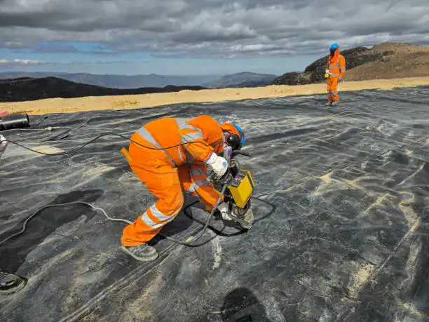 Geomembrane installation using hot wedge welding and air pressure testing for seam integrity QA/QC