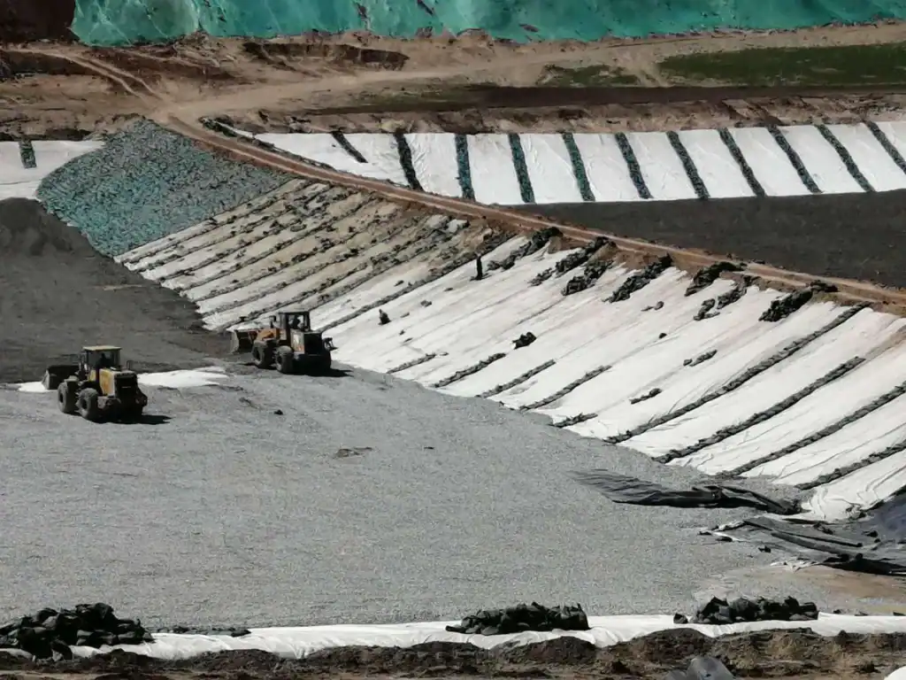 HDPE geomembrane liner installation for mining heap leach pad containment and solution collection