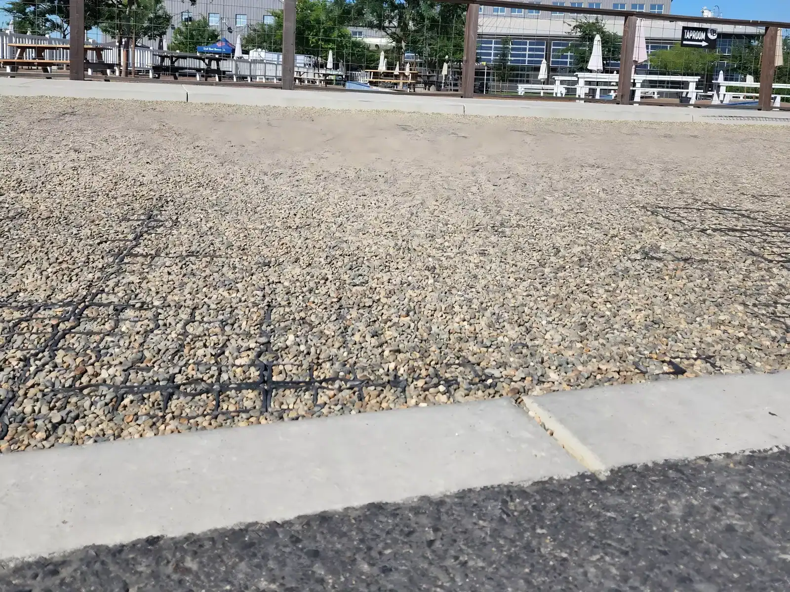 Permeable gravel driveway grid installation preventing rutting and allowing water drainage for vehicles
