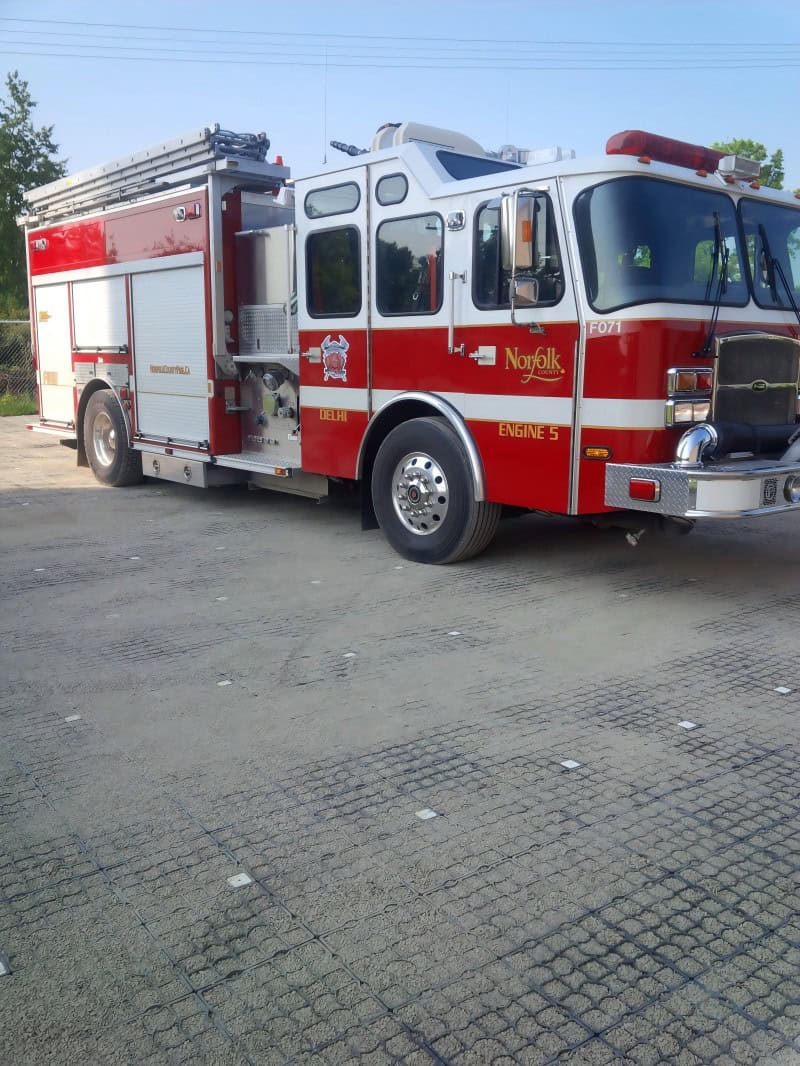 Fire engine parked on grass paver grid surface demonstrating load-bearing capacity during fire department approval test