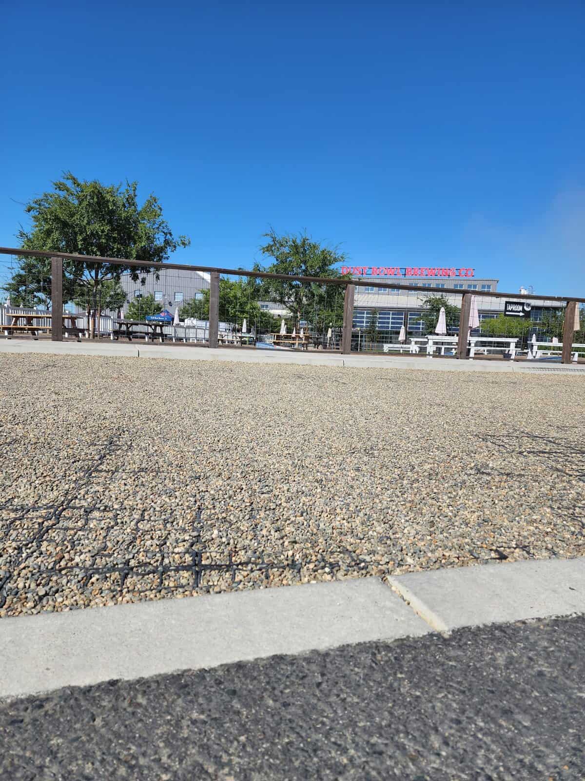 Established grass paver fire lane showing turf growing through grid cells blending seamlessly into surrounding natural lawn