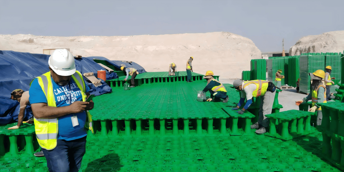 Workers installing ARW geocellular stormwater modules at a logistics park construction site in Dubai South