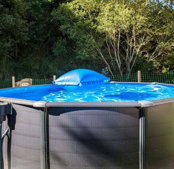 Ronde tuinzwembad met blauwe drijver erin.
