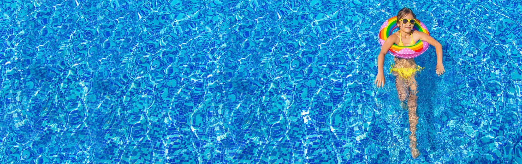 the child swims with a circle in the pool. selective focus.
