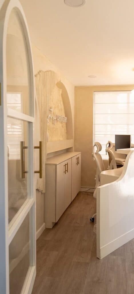 Comfortable, welcoming dental office reception area featuring ergonomic chairs, computer workstations, and stylish decor for a positive patient experience.