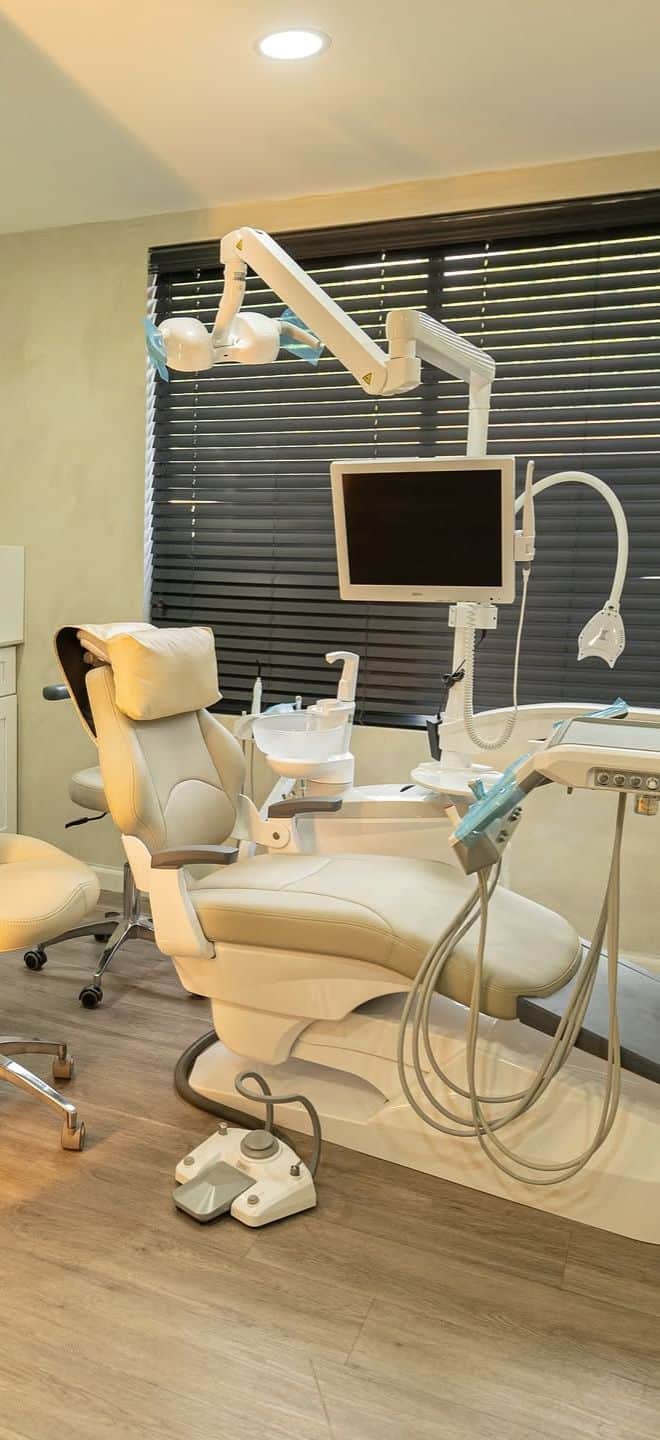 High-quality dental chair with state-of-the-art dental instruments and monitor at Art of Dentistry, Jamaica, for comprehensive dental care and patient comfort.