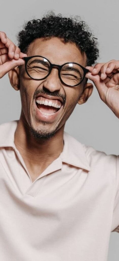 Person smiling happily, showing beautiful teeth.