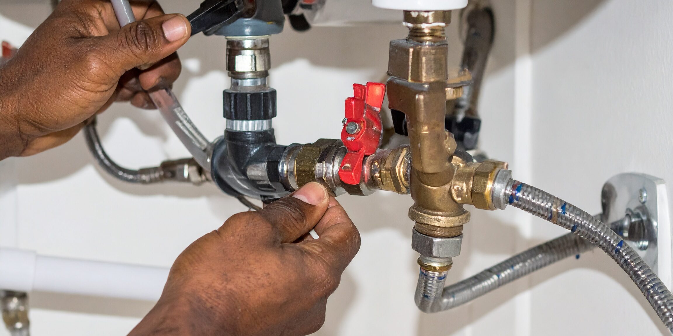 Plumber-Installing-Water-Heater-Pipe-Connections