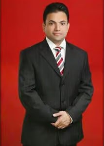 ASG Hair Transplant Centre professional doctor in a suit with a red background.