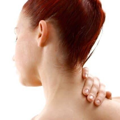 A young factory worker strains his neck and shoulder in visible pain, representing cervical spondylosis—treated through manual therapy at our health clinic in Higham Ferrers.