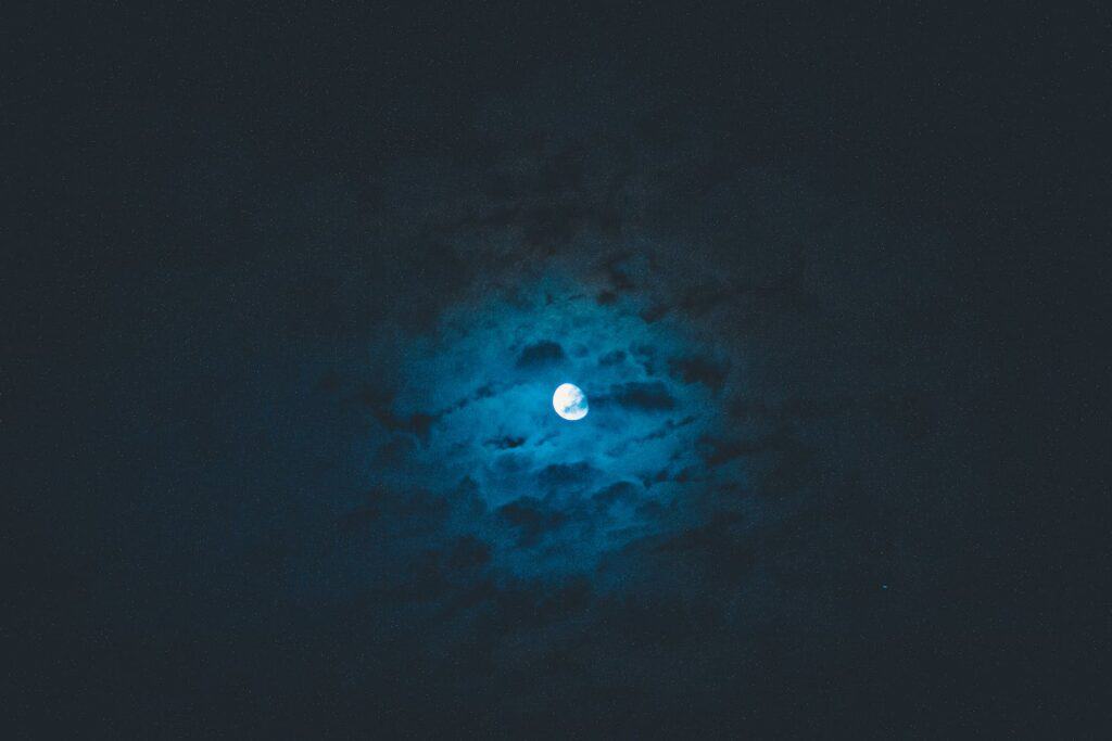 Moon shining on dark sky