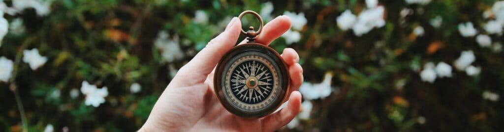 person holding compass
