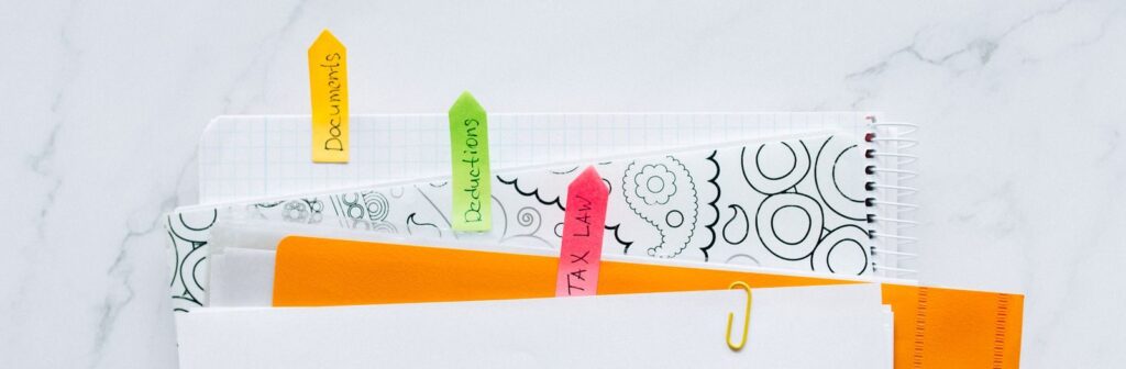Colorful tabs organizing tax documents for easy filing and reference.