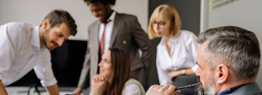 A diverse group of professionals engaging in a collaborative meeting in a modern office setting.