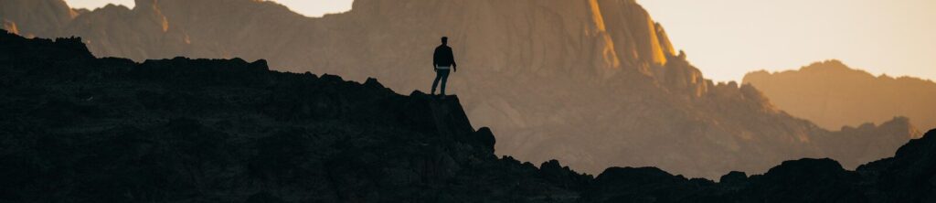 a person standing on top of a rocky hill