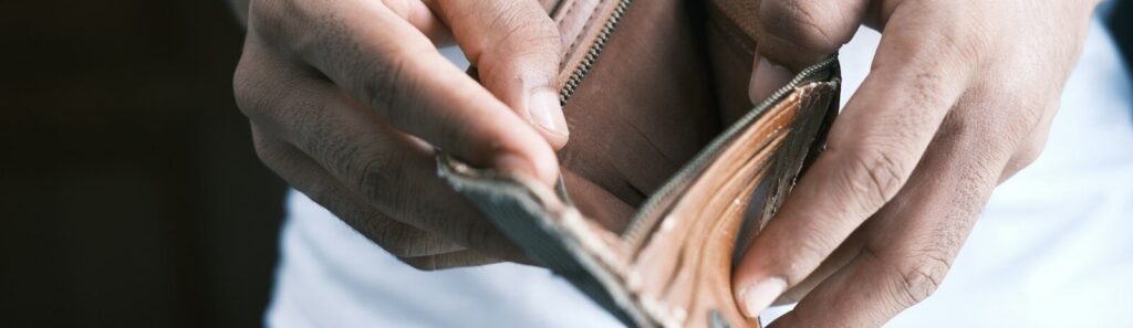 person holding brown leather bifold wallet