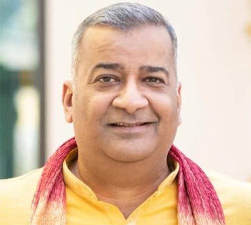 Elegant man in traditional attire promoting Astro Vastu House services.