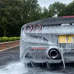 Luxury car covered in foam being washed