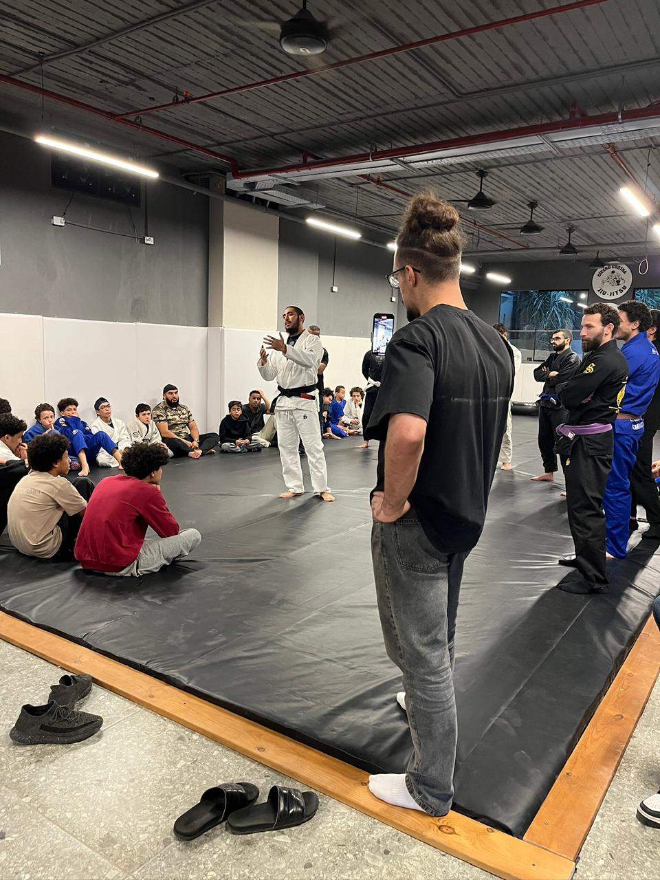 Atom Jiu Jitsu head coach speaking to kids and adults during the grand opening class at the new academy