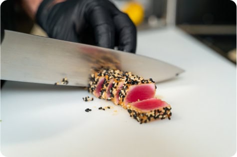 Fresh seared tuna with sesame crust being sliced at Attwood's Kitchen & Drink.