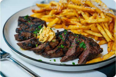 Juicy grilled steak served with crispy French fries at Attwood's Kitchen & Drink.