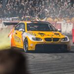 Tuningované auto driftující s kouřem z pneumatik na závodní akci