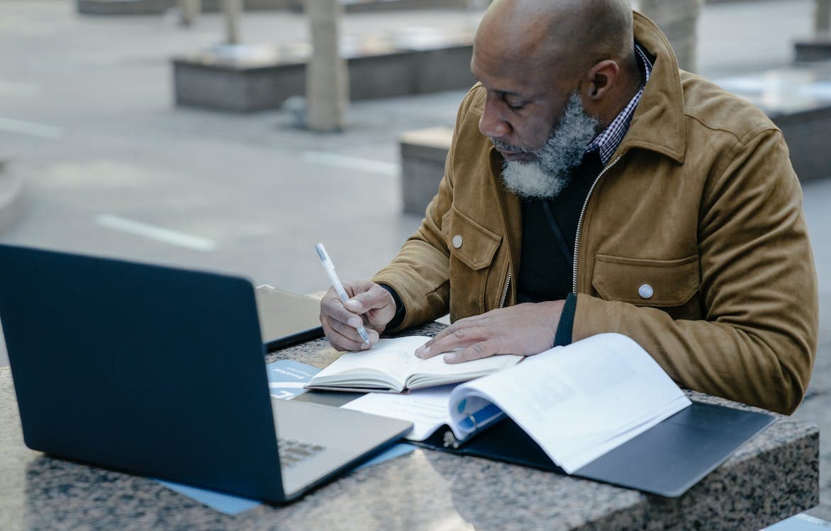 What To Look for in AV Installation Companies A man sits at a table outdoors with a laptop in front of him