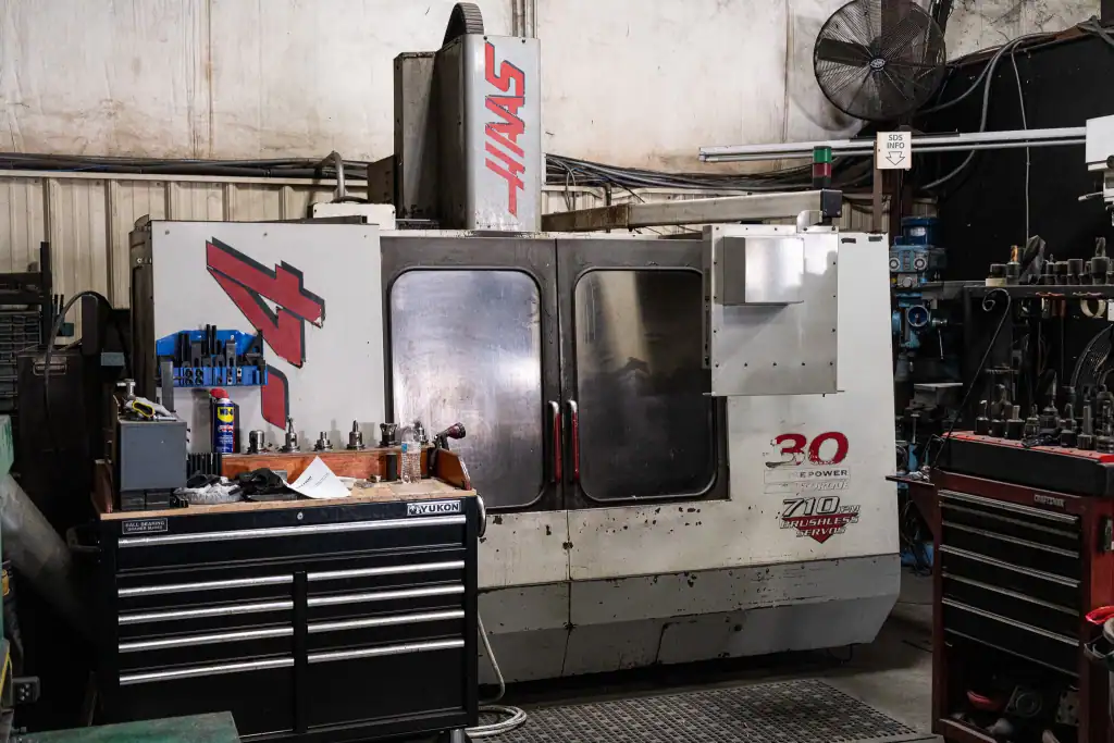 Industrial metal fabrication machine at B&B Powder facility. Precision manufacturing for custom meta.