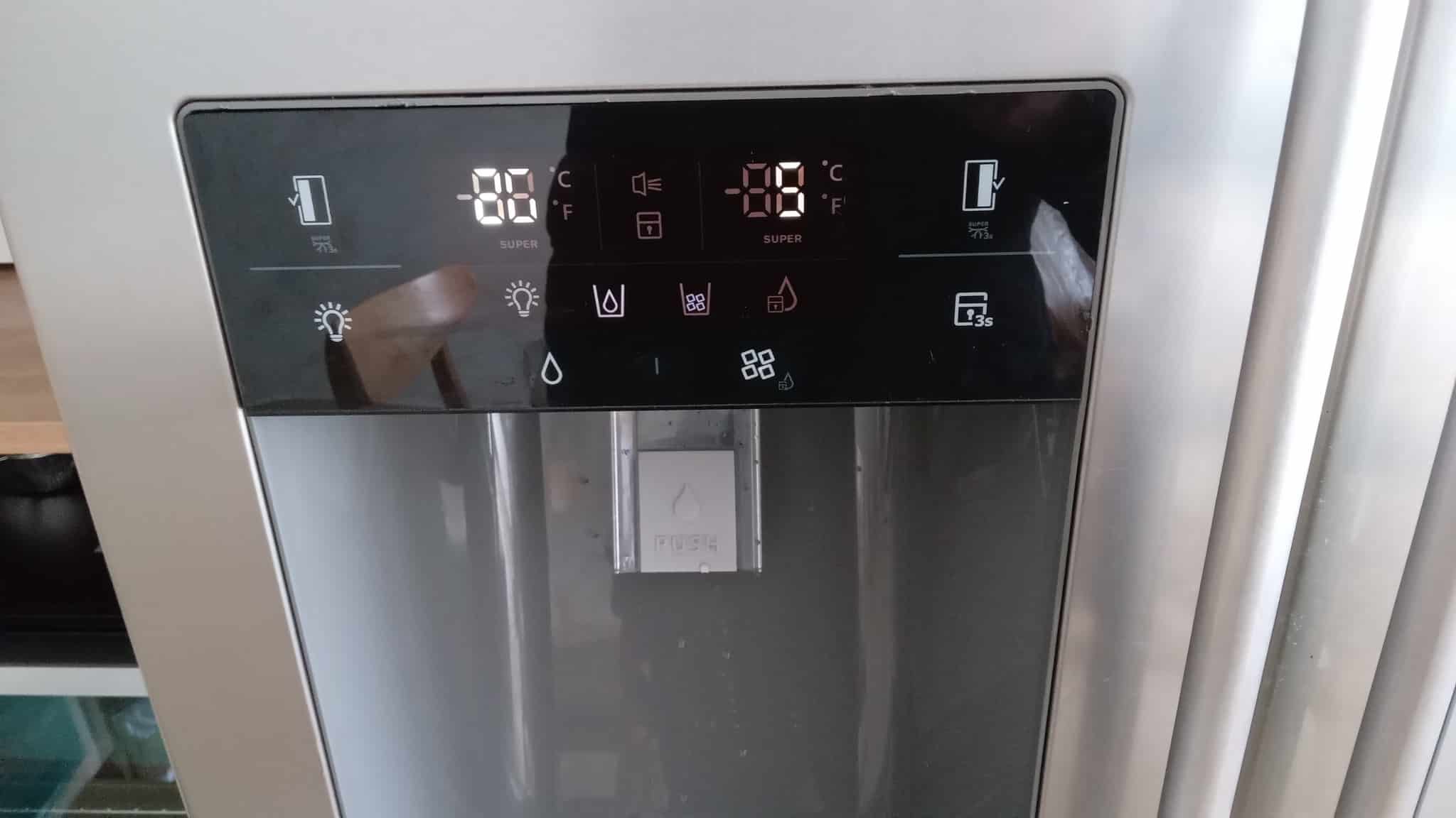 Efficient LG refrigerator with digital control panel showing temperature settings and water dispenser for reliable cooling and water supply.
