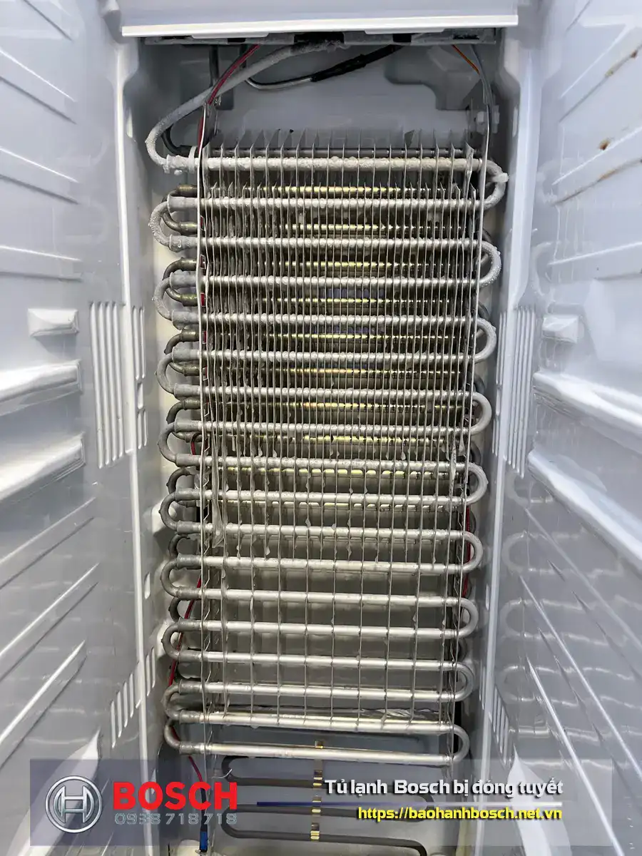 Condensing coil inside a Bosch refrigerator for cooling efficiency and warranty support.