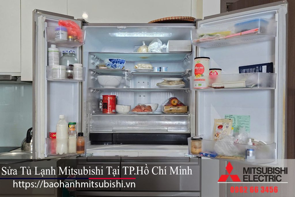 Clean, organized Mitsubishi refrigerator open with fresh fruits, vegetables, and beverages, showcasing quality Mitsubishi electric appliances for optimal food preservation.