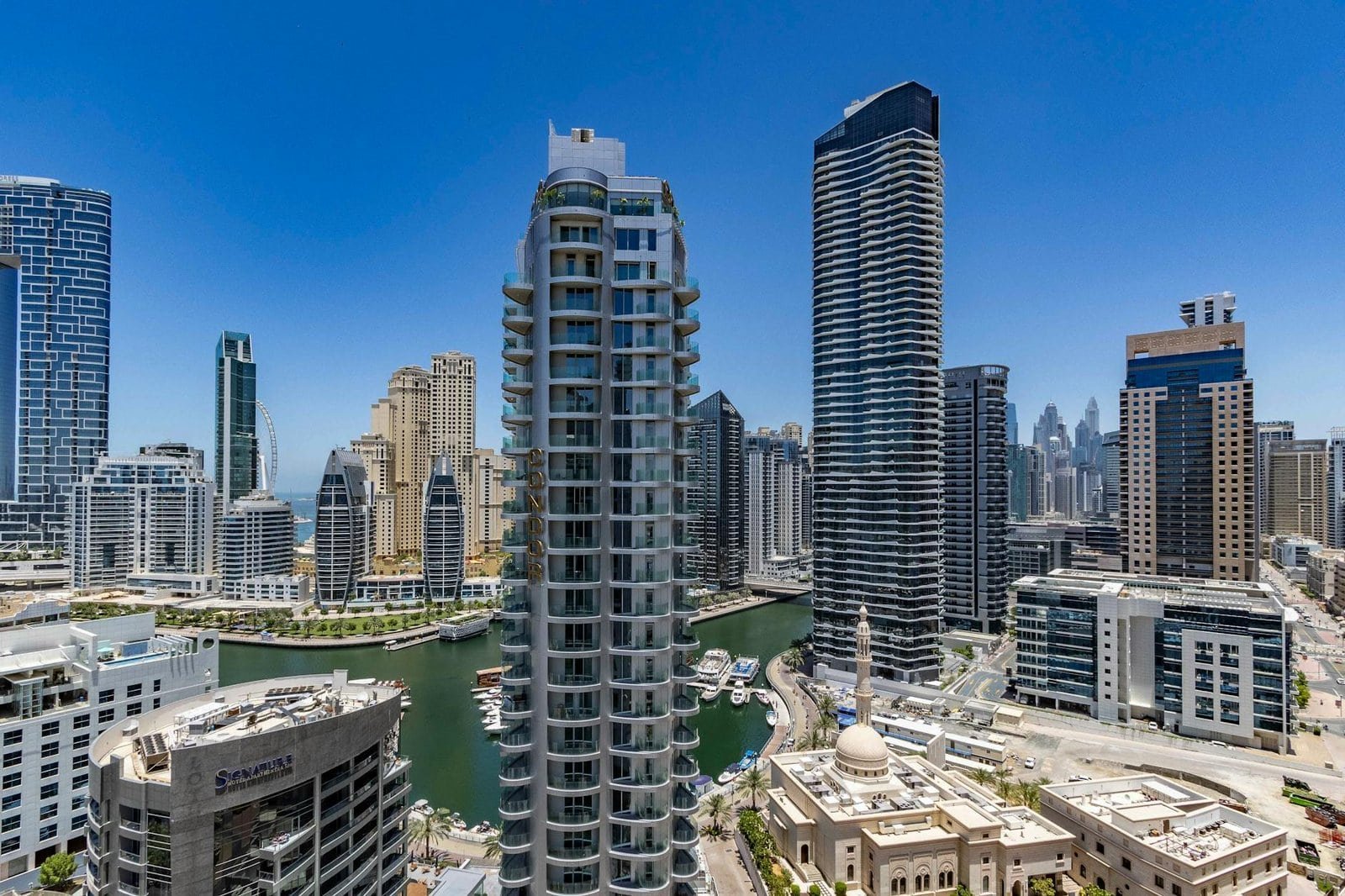 Modern high-rise buildings in Dubai Marina with stunning cityscape and water views.
