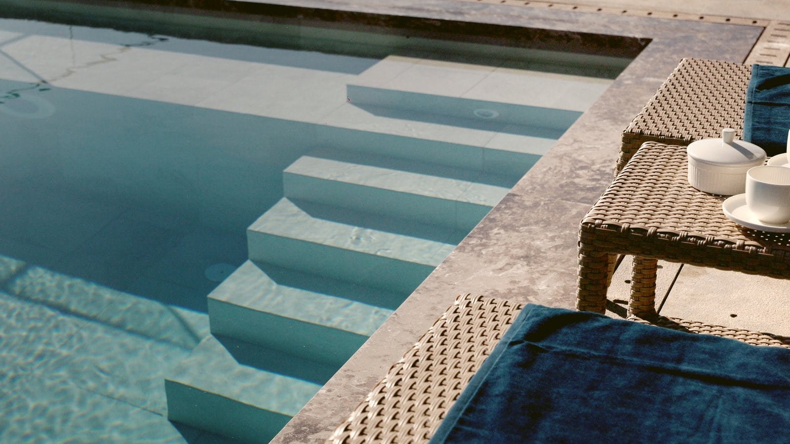 Modern swimming pool with sea view and sun loungers in Montenegro luxury villa.