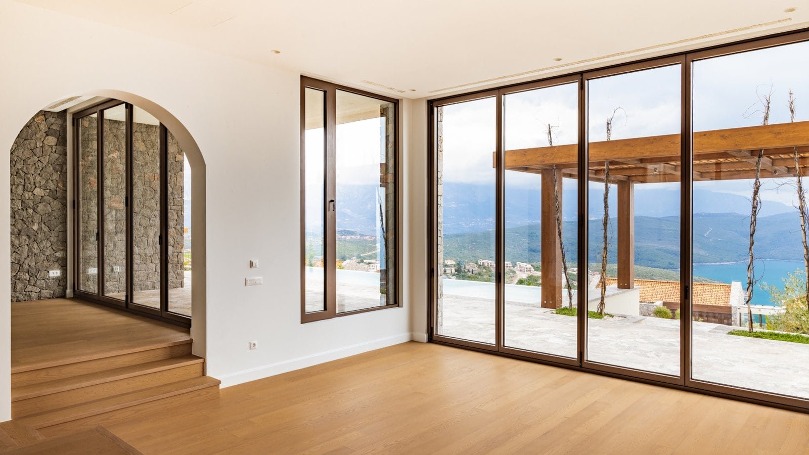 Modern luxury villa in Montenegro with panoramic Adriatic Sea views and spacious glass windows.