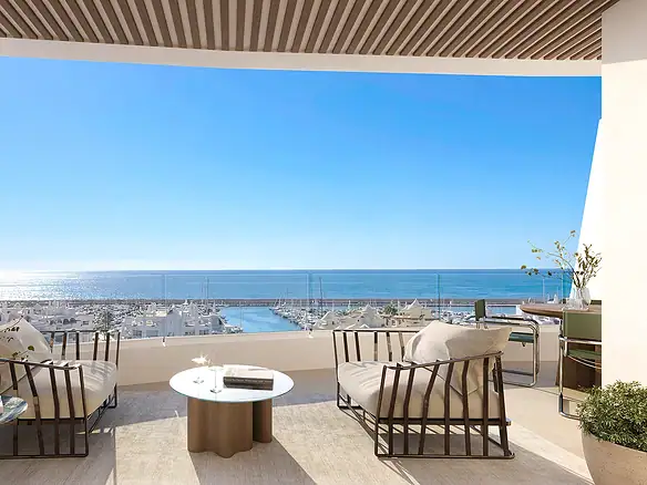 Luxury balcony overlooking Marina Golden Bay in Benalmádena, Costa del Sol, with modern seating and.