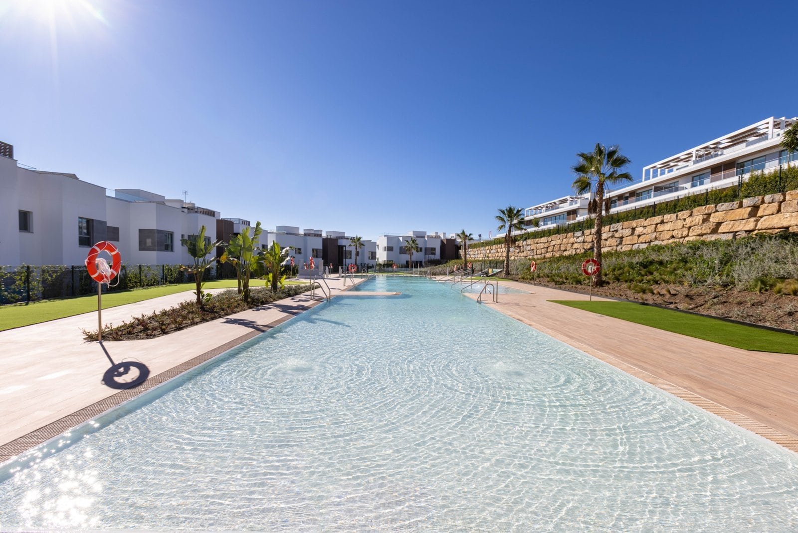 Poolside view at Santa Clara Golf Apartments Marbella, frontline golf residences with modern ameniti.