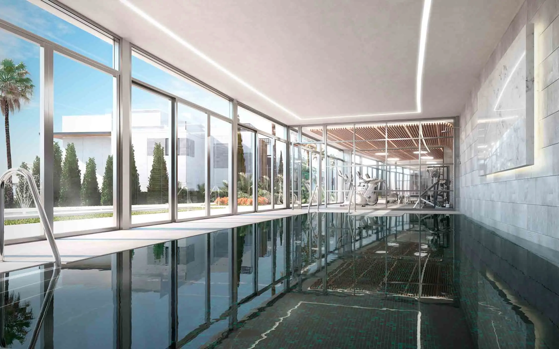Indoor swimming pool with large glass windows overlooking the golf course in Marbella. Luxurious ame.