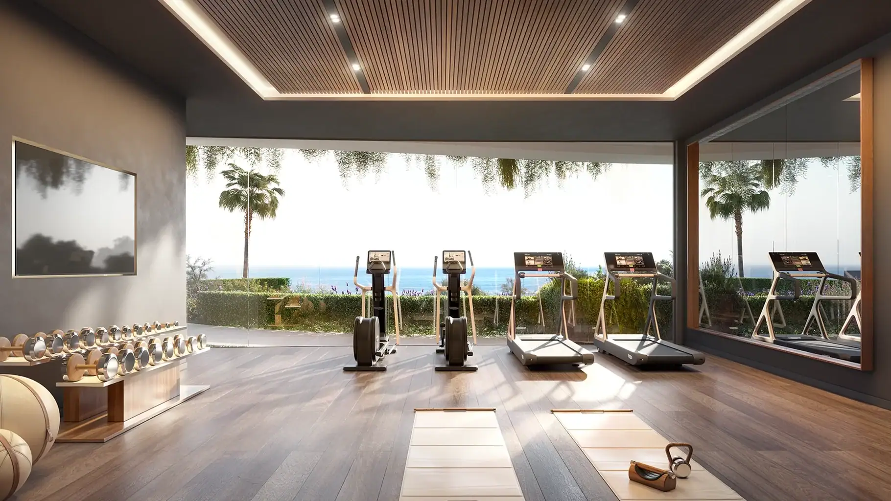 Gym interior with panoramic sea views, fitness equipment, and natural light in Benalmádena.
