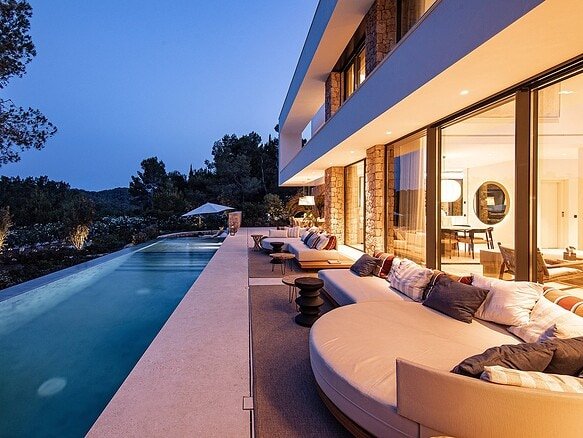 Luxurious villa at Corallisa Ibiza with private pool and modern outdoor lounge area.
